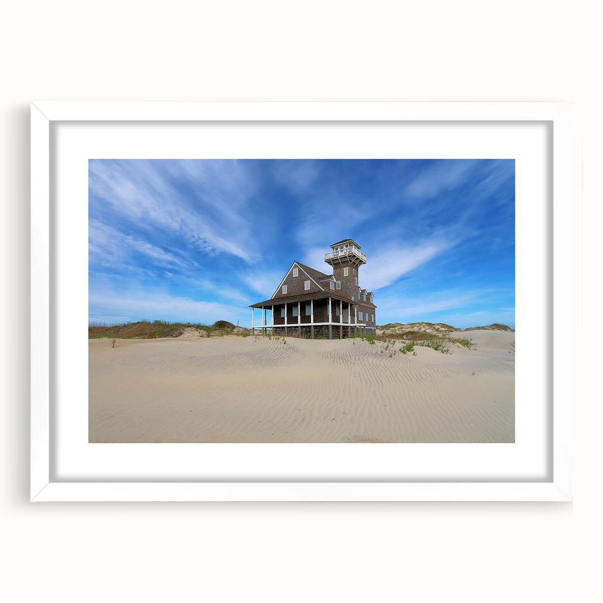Abstract art print of North Carolina's Outer Banks in muted blue and gray tones on a white framed canvas.