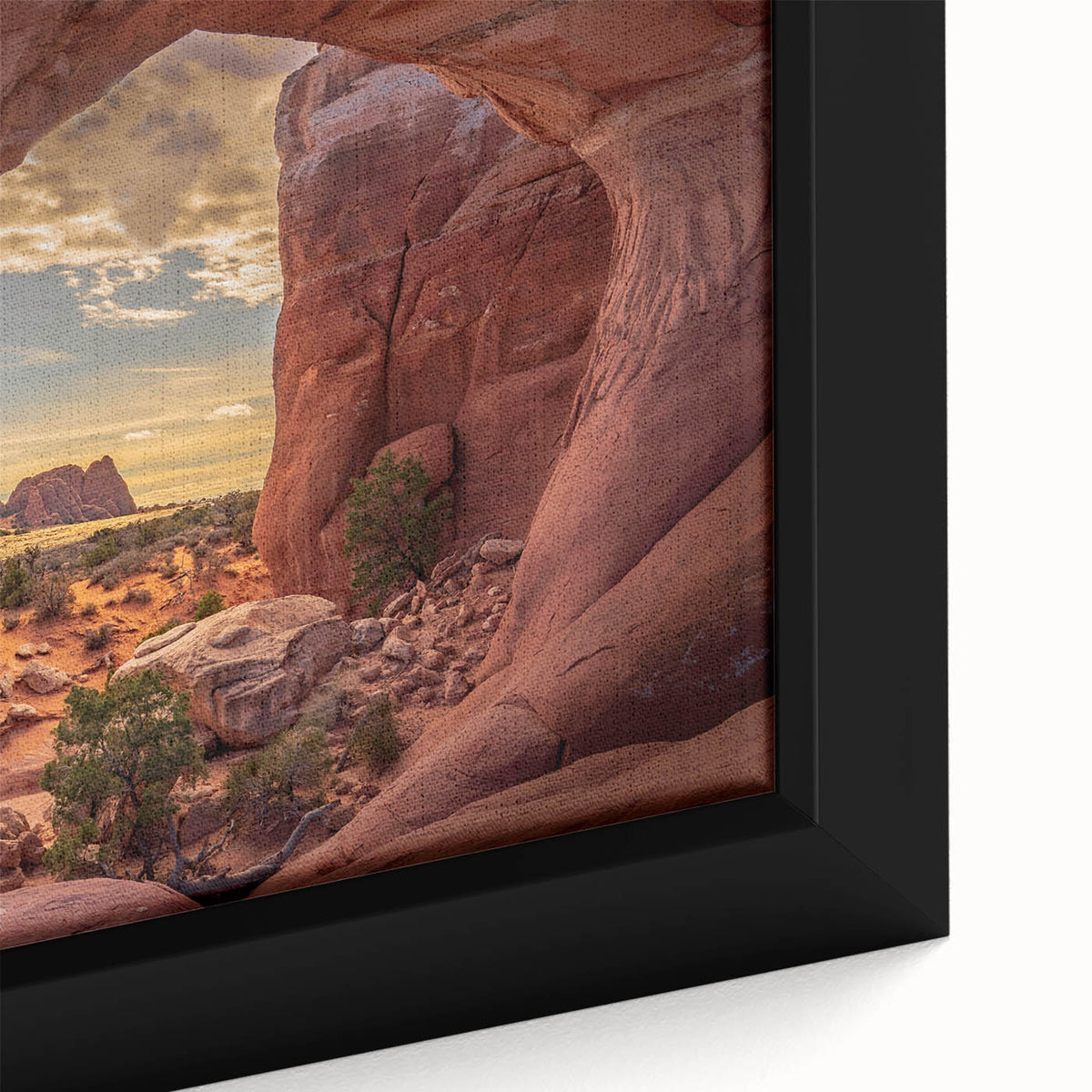 Close-up of a black framed canvas depicting Arches National Park in vibrant, textured colors, ideal for living room decor.