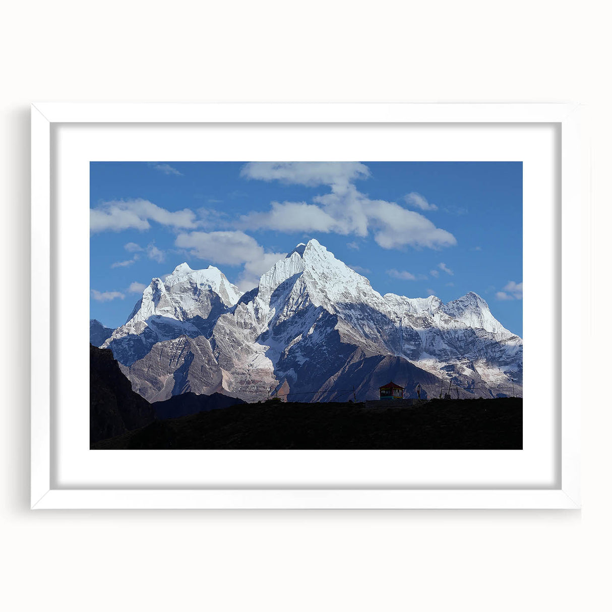 Abstract art print of a serene Nepalese landscape in muted earth tones on a framed white mat, ideal for dining room decor.