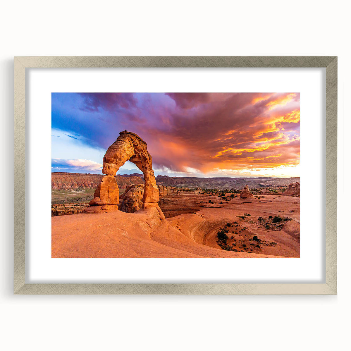 Textured art depicting Arches National Park in muted earth tones, framed in silver, ideal for bedroom art.