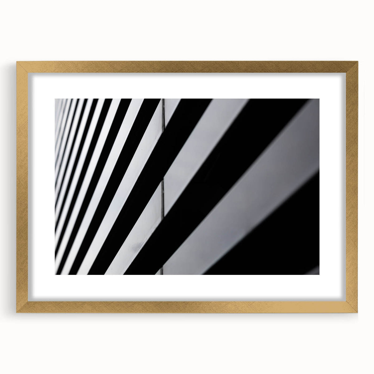 Abstract art print of Amsterdam with muted earth tones in a gold frame, suitable for dining room decor.