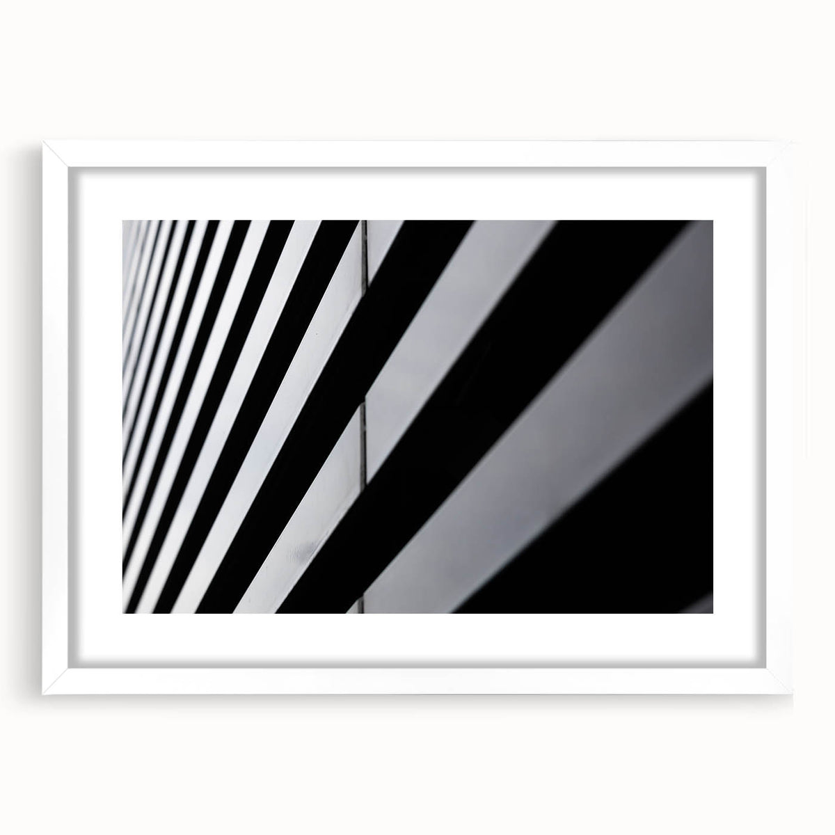 Textured art depicting an abstract Amsterdam canal scene in muted blue and gray tones, framed with a white mat.