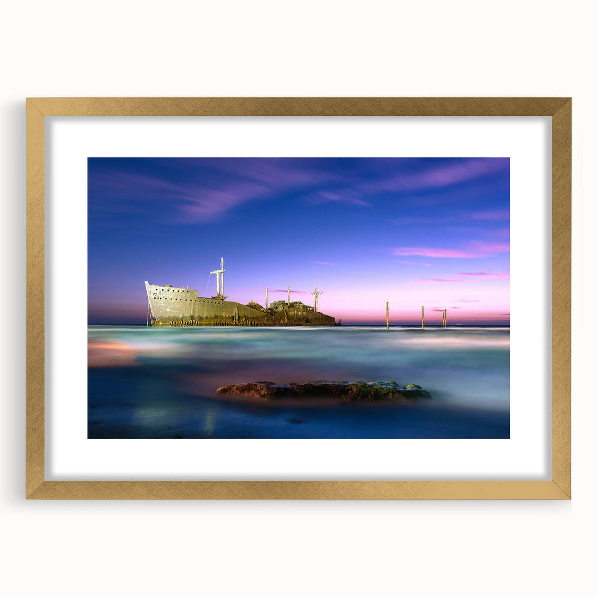 Extra large wall art featuring an abstract depiction of a Middle Eastern scenery in textured gold tones, framed with a mat.