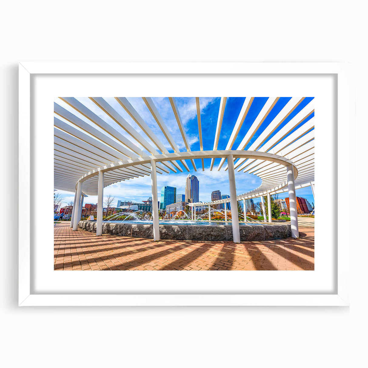 Abstract art print of Charlotte skyline in muted gray and blue tones on a framed white mat, suitable for dining room decor.