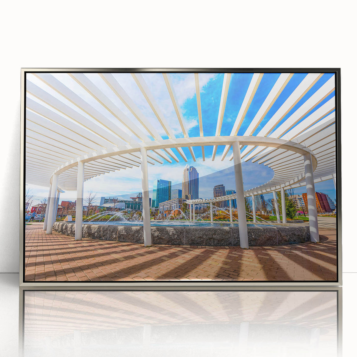 Mid-century modernist art of Charlotte skyline in muted gray and blue tones on framed acrylic.