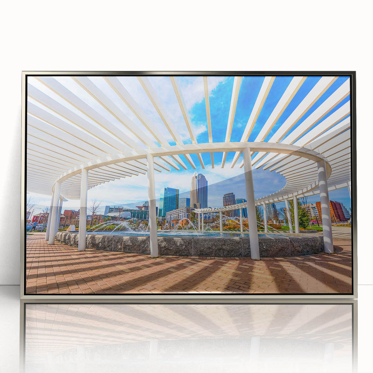 Mid-century modernist art of Charlotte skyline in muted gray and blue tones on framed acrylic.