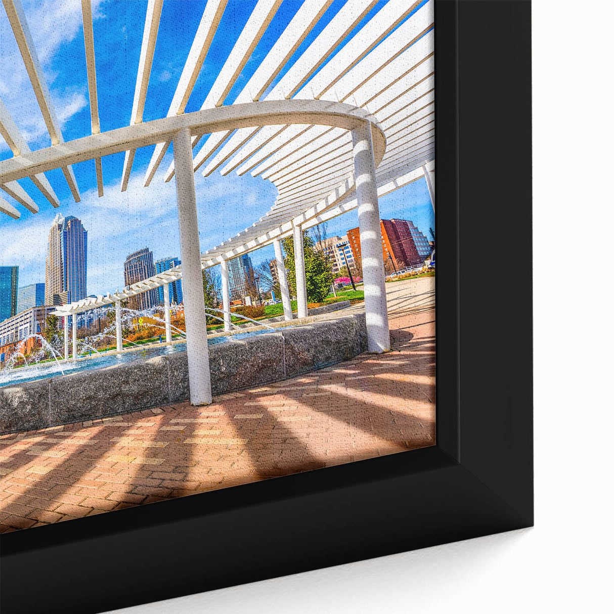 Textured black wall art depicting the Charlotte skyline with colorful accents on a framed canvas.