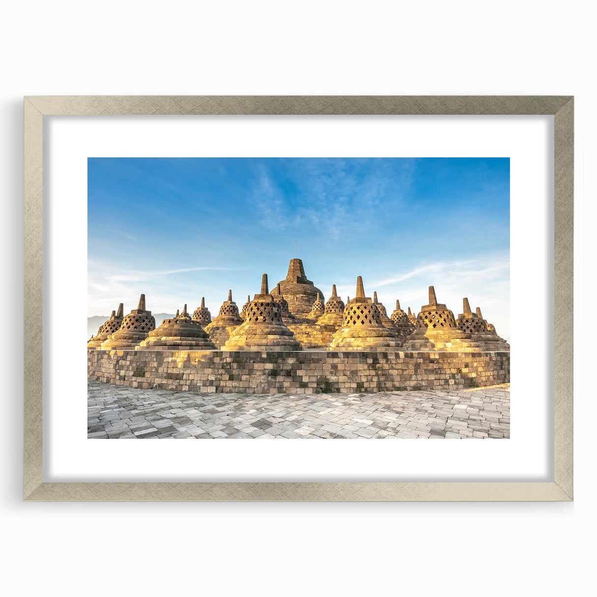 Textured abstract art print depicting a serene Indonesian landscape in muted earth tones, framed in silver.