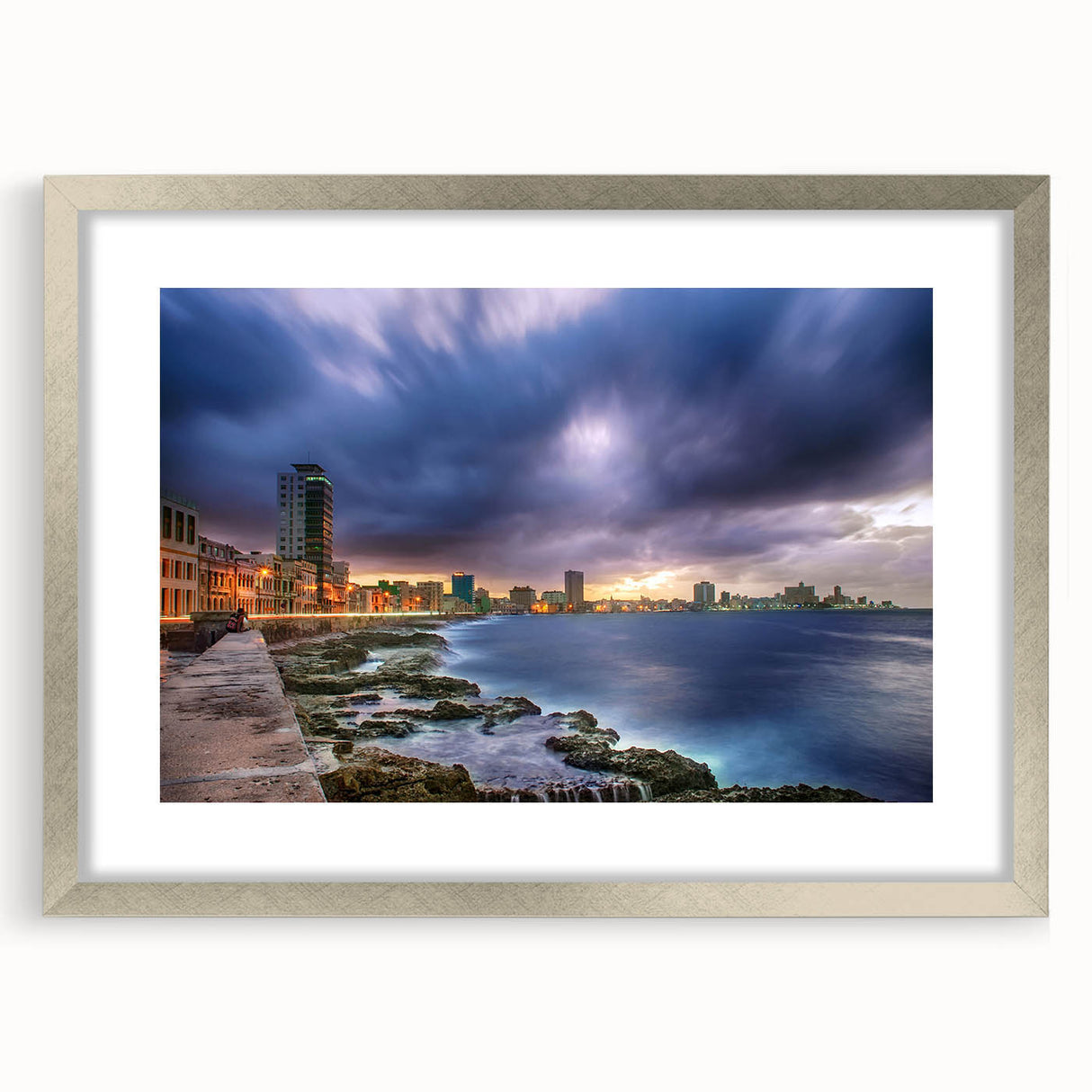 Textured abstract art print of a Caribbean scene in muted blue and green tones, framed in silver.