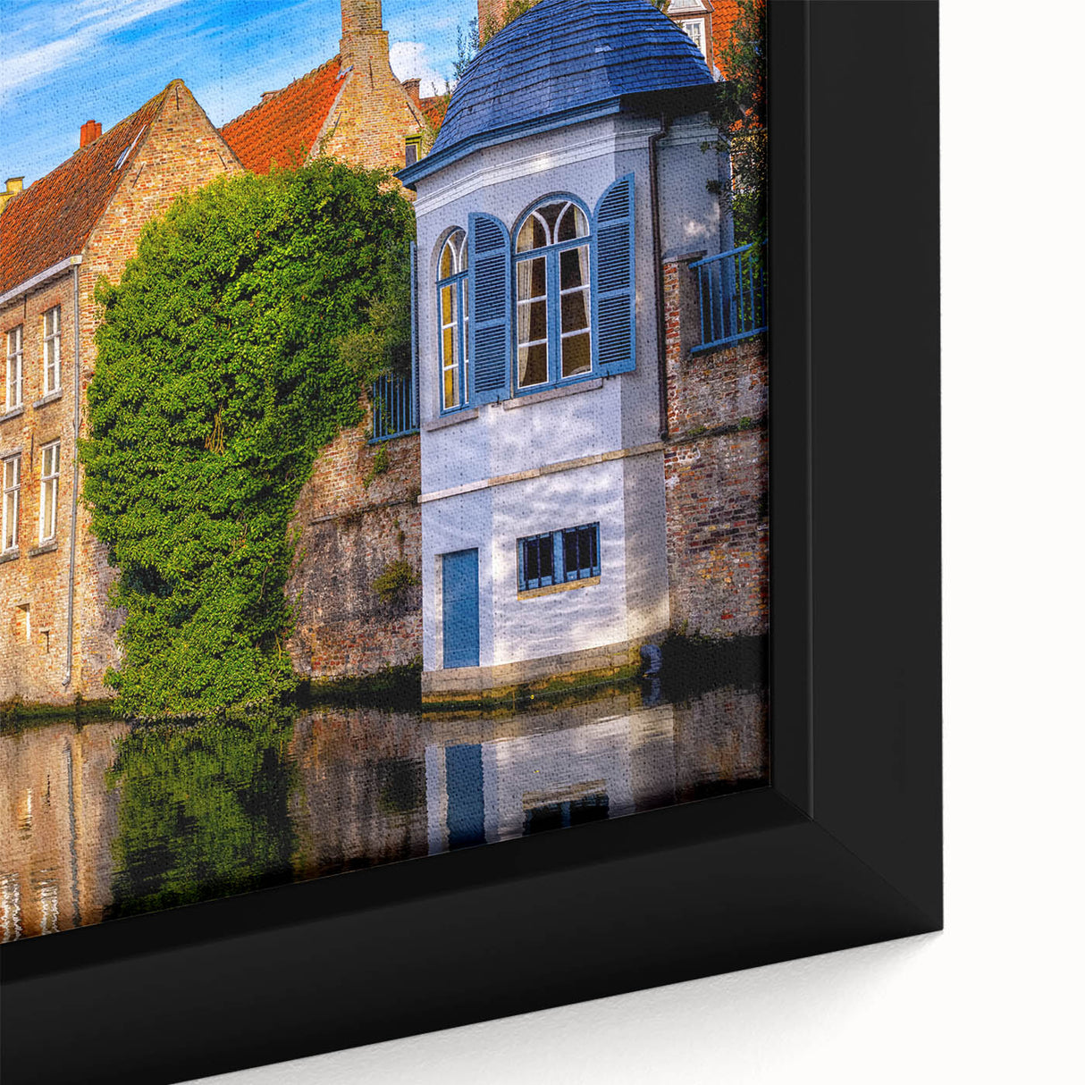 Close-up of textured black wall art featuring a colorful European scenery on framed canvas, ideal for living room decor.