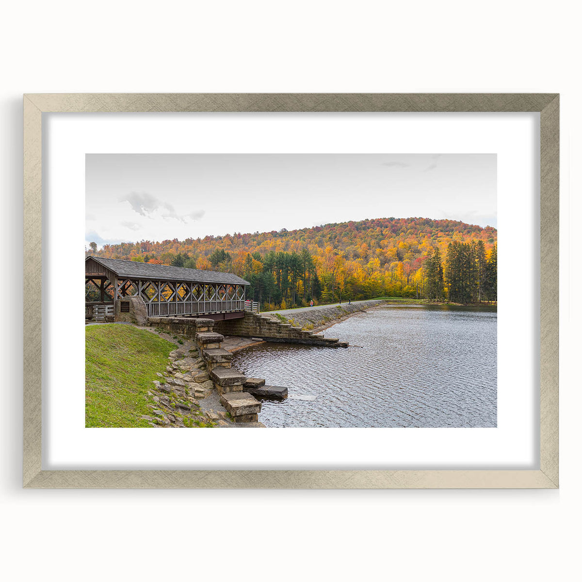 Textured art depicting an abstract landscape in muted earth tones, framed in silver, ideal for bedroom decor.