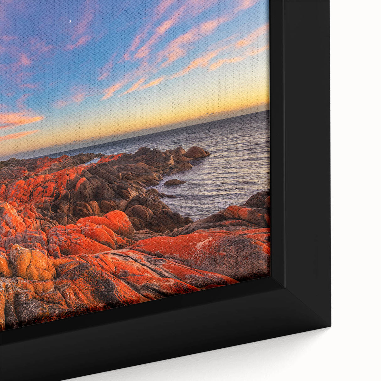Black wall art featuring a textured depiction of Tasmania scenery in vibrant colors on a framed canvas.