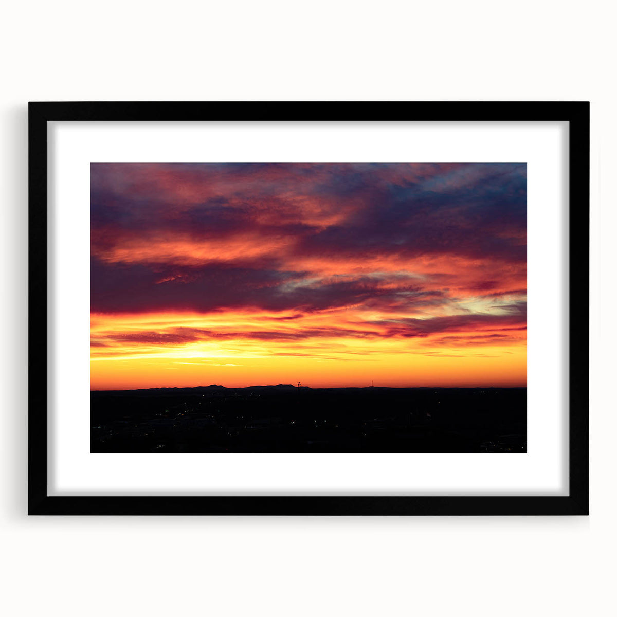 Extra large abstract art print of colorful, textured Charlotte skyline on a framed black mat, ideal for living room decor.
