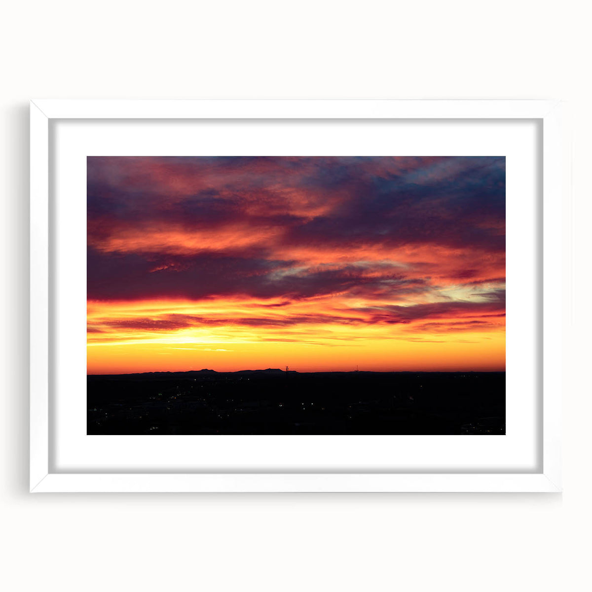 Abstract art print of Charlotte skyline in muted gray and blue tones on a white framed canvas.