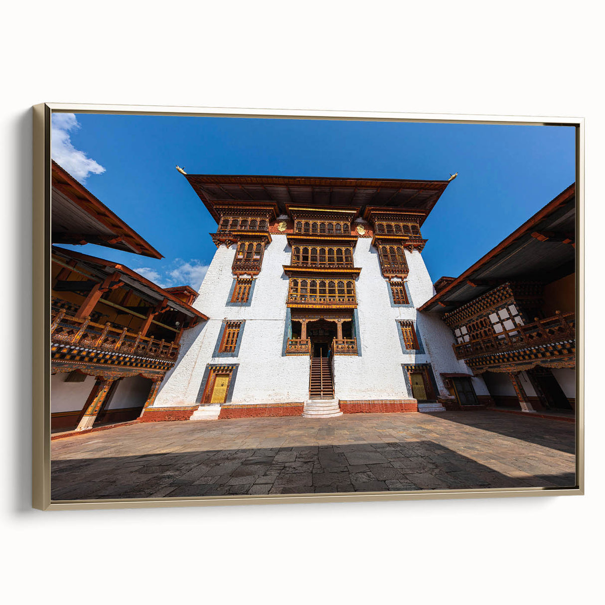 Framed canvas featuring a landscape painting of Bhutan in muted gold and black tones, ideal for bedroom decor.