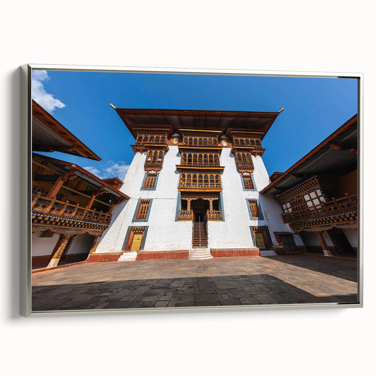 Framed canvas featuring a vintage-style landscape painting of Bhutan with colorful art elements on a black background.