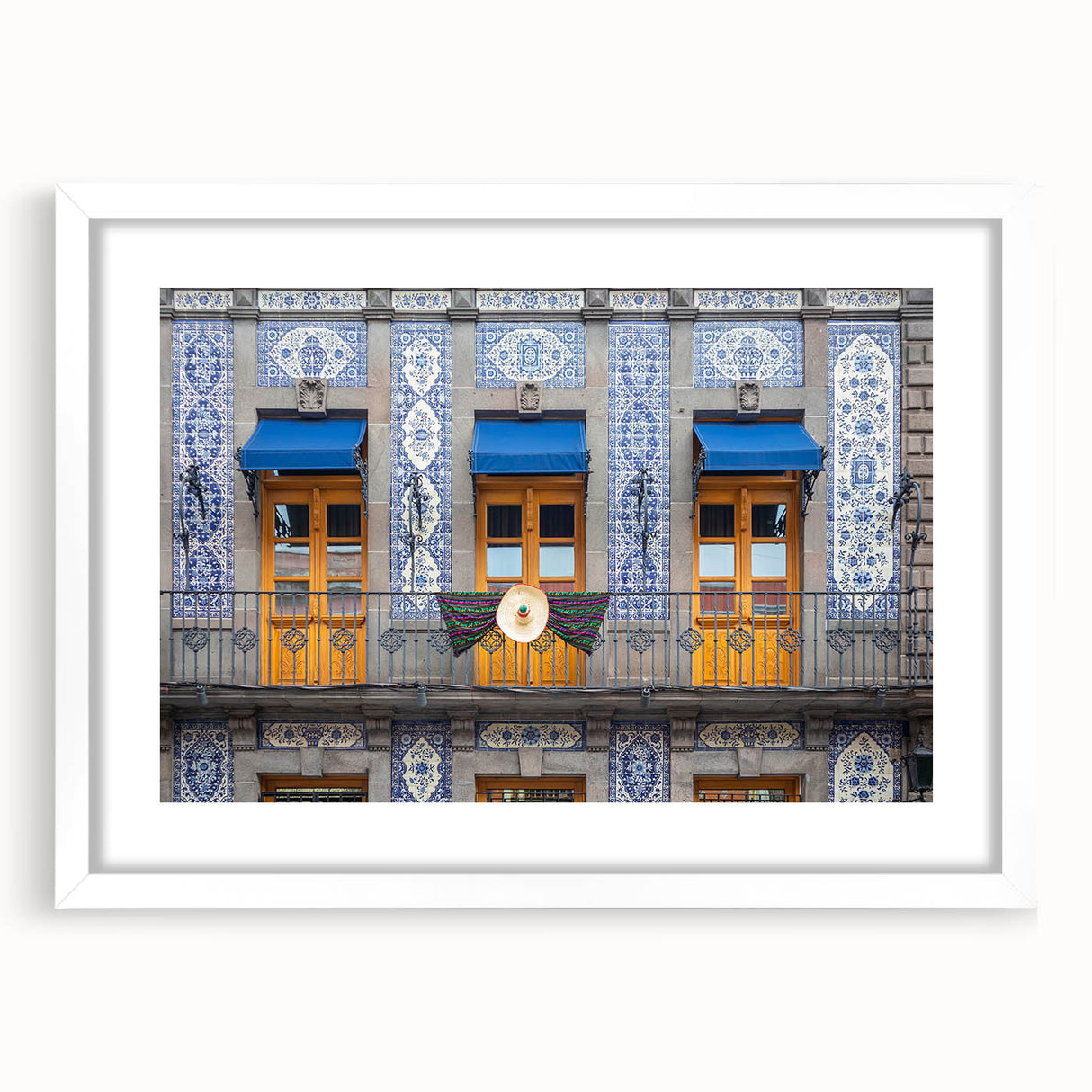 Abstract art print of Mexico City with muted colors on a white framed mat, suitable for dining room decor.