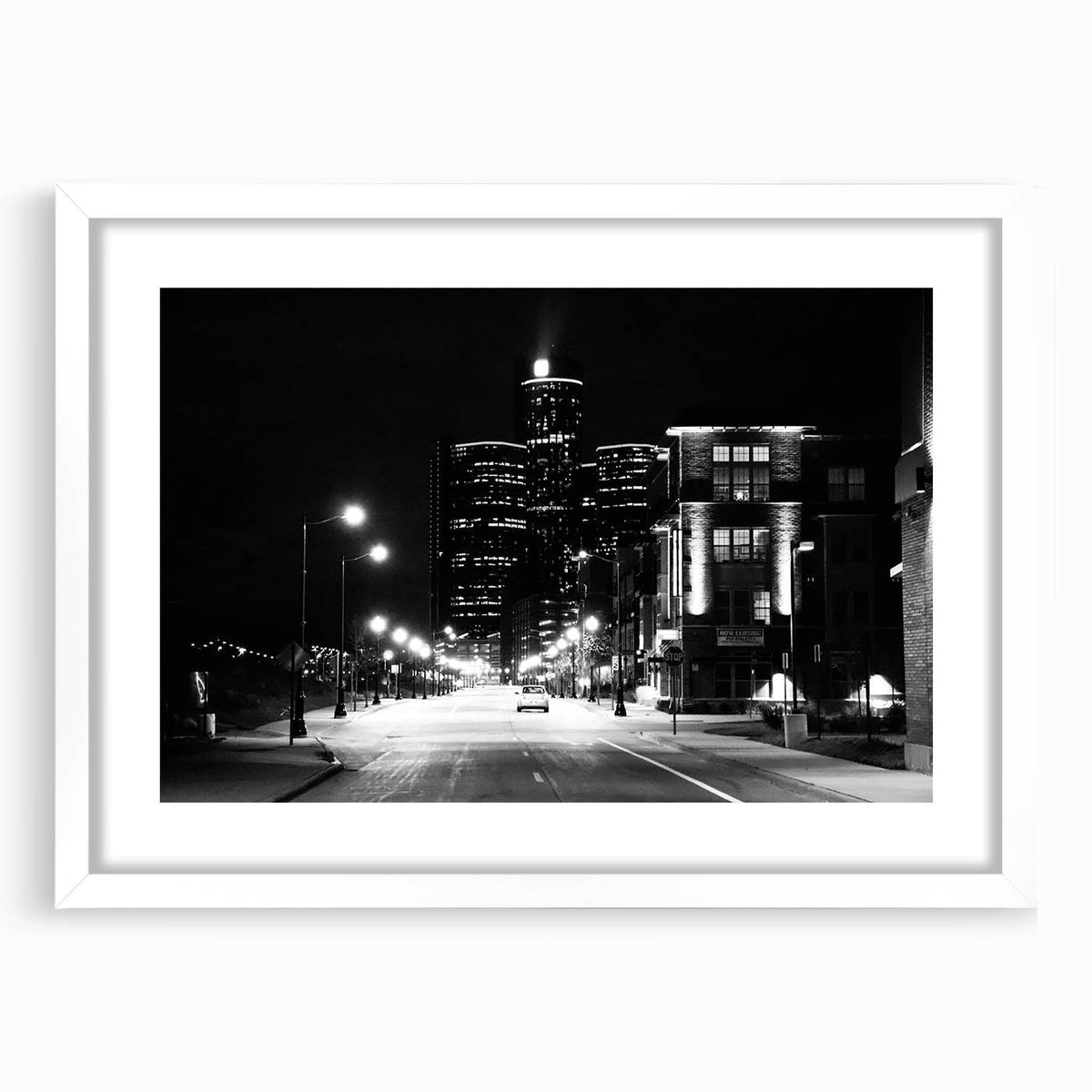 Abstract art print of Detroit skyline in muted gray and blue tones, framed with a white mat.
