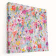 Stretched canvas wall art displaying vibrant abstract floral designs in shades of blue, pink, and gold, showcasing a modern and artistic home decor style.