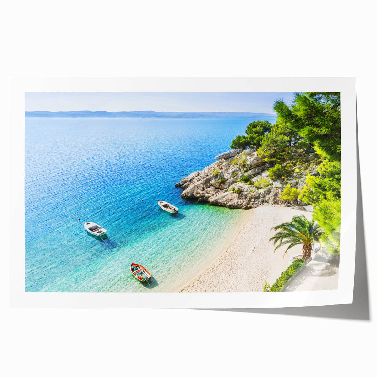 Rolled print of a Croatian landscape with lush greenery and distant hills, in soft earth tones.
