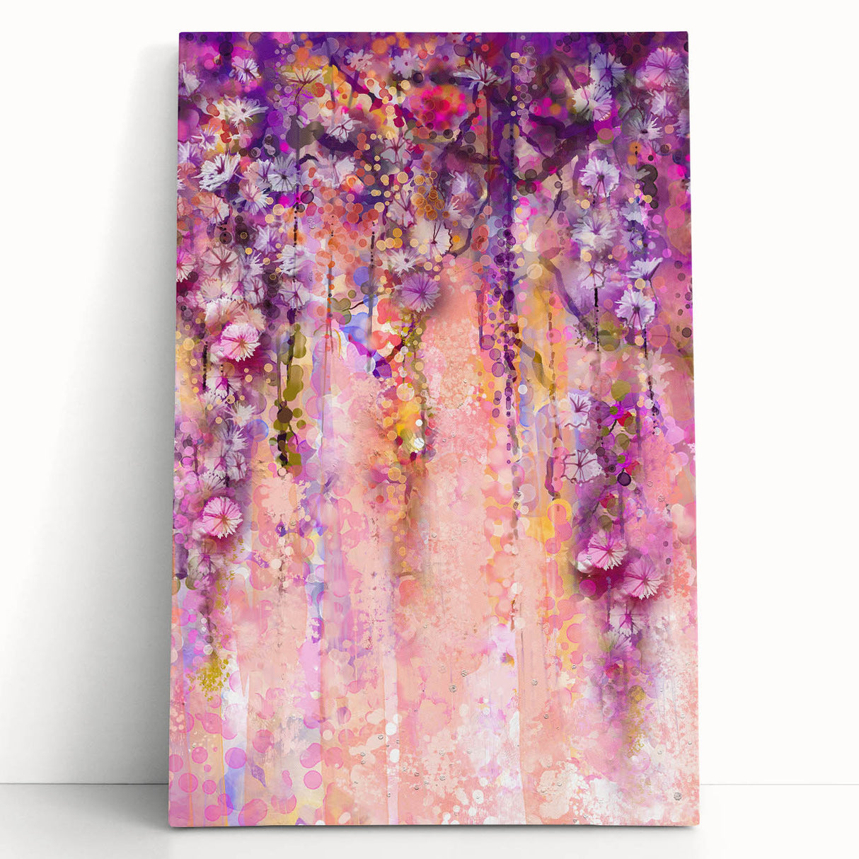 Abstract floral canvas art featuring vibrant pink, blue, and yellow blooms against a textured background, leaning against a wall, perfect for modern home decor.