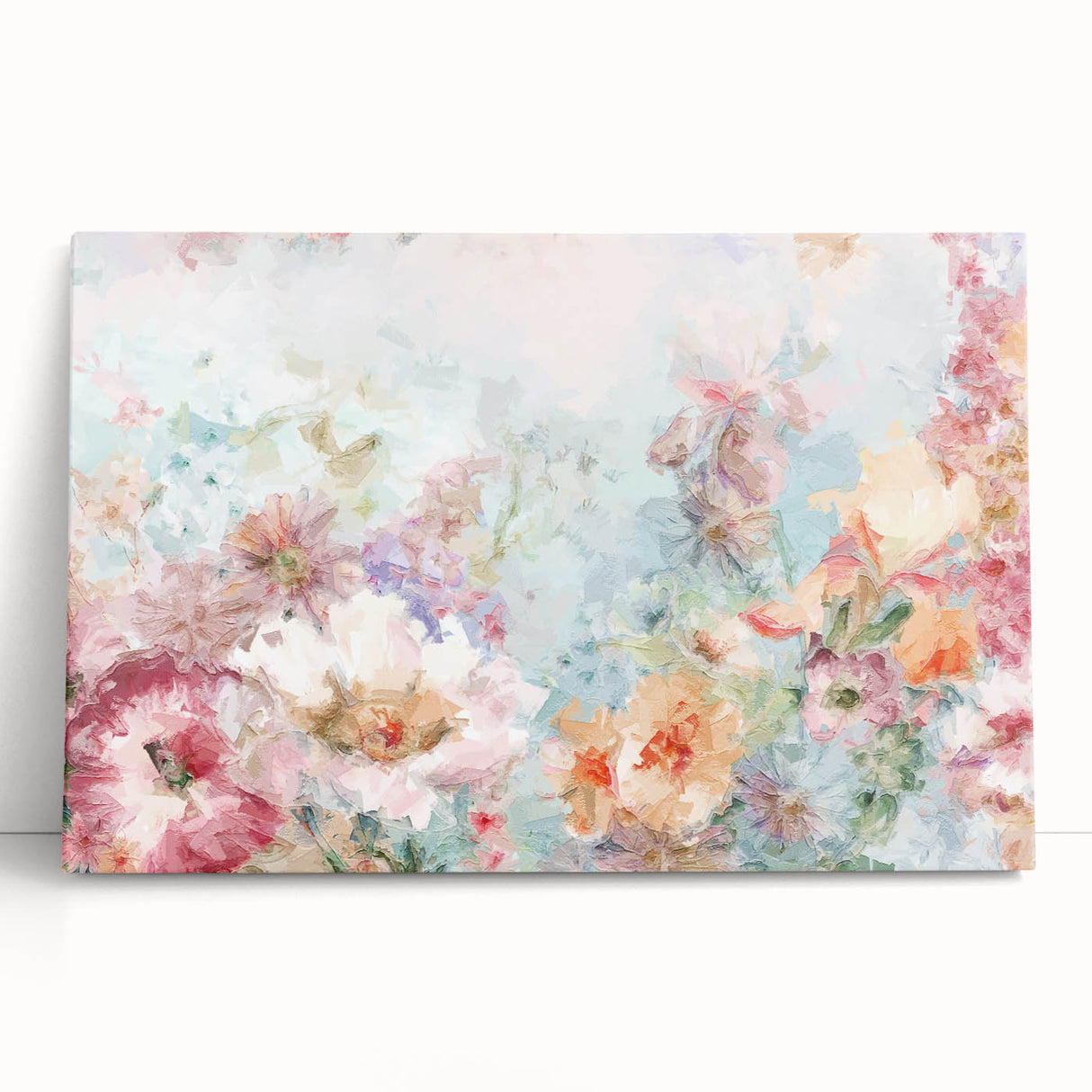 Abstract floral design stretched canvas artwork featuring vibrant hues of blue, pink, and green, elegantly leaning against a neutral wall, perfect for modern home decor.