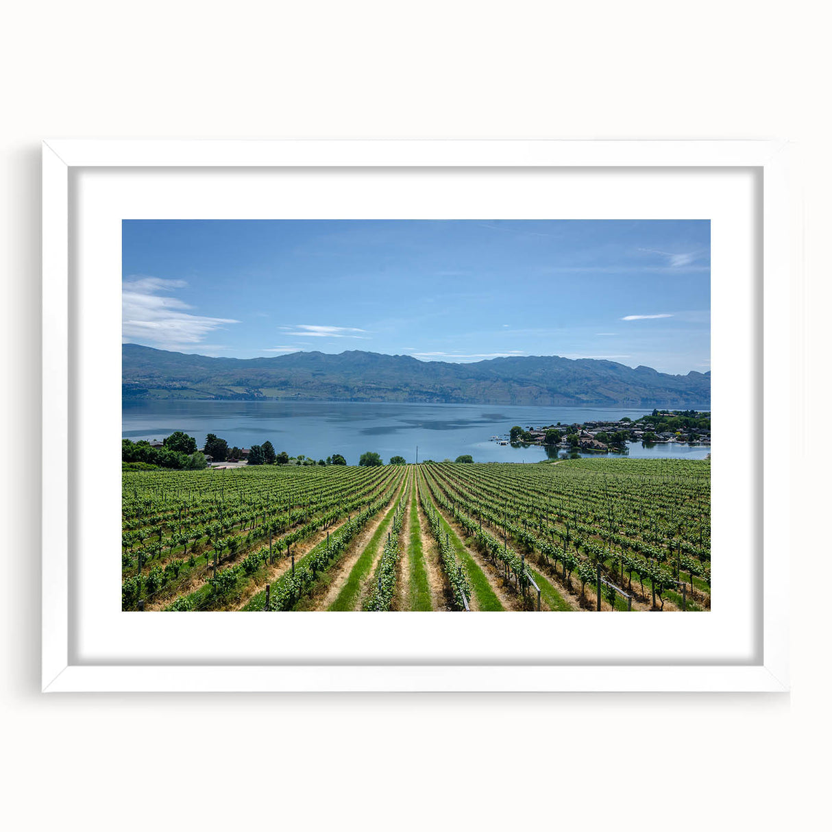 Abstract art print of a British Columbia landscape in muted green and blue tones, framed with a white mat.