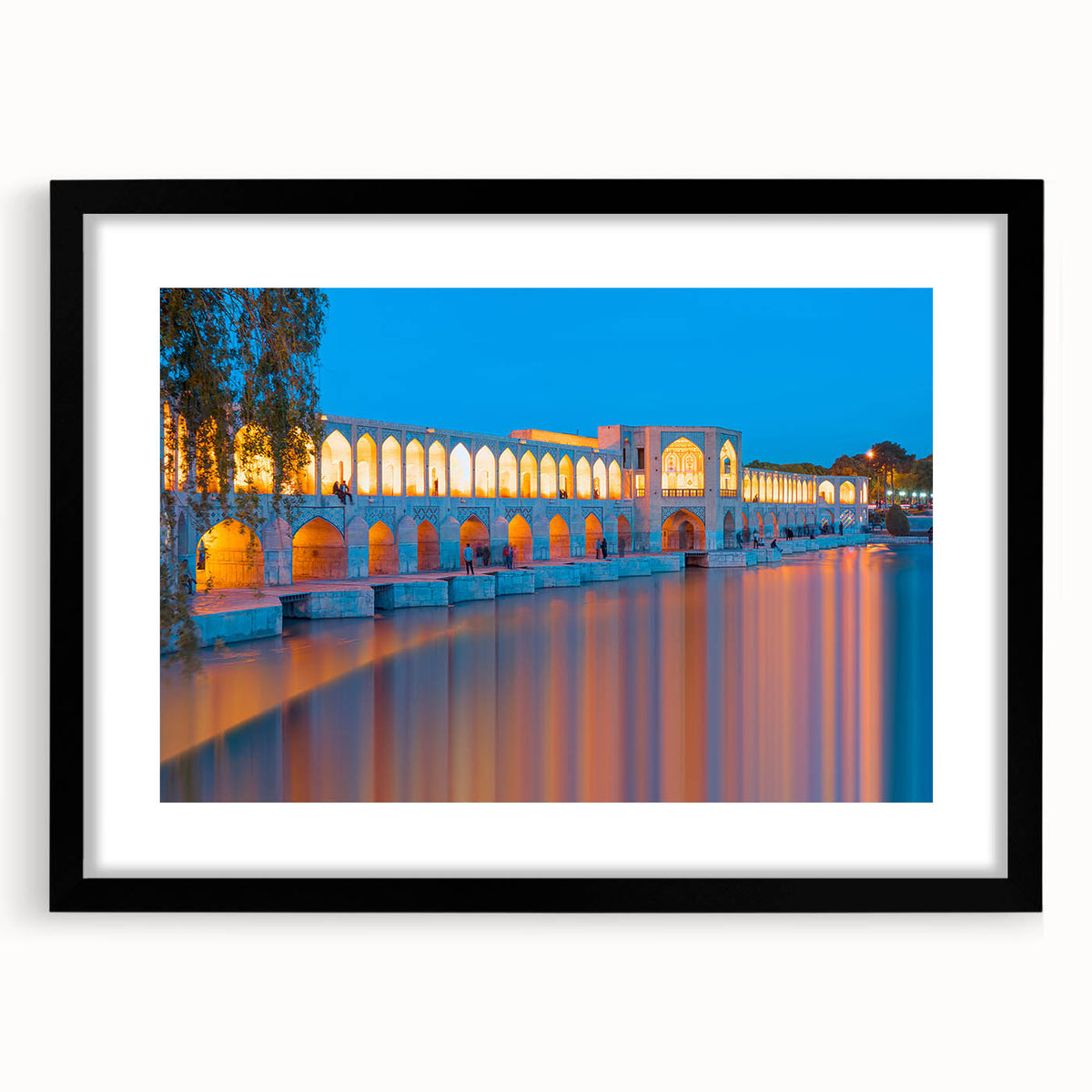 Abstract art print featuring a colorful, textured scenery of a Middle Eastern landscape, in a black frame with mat.