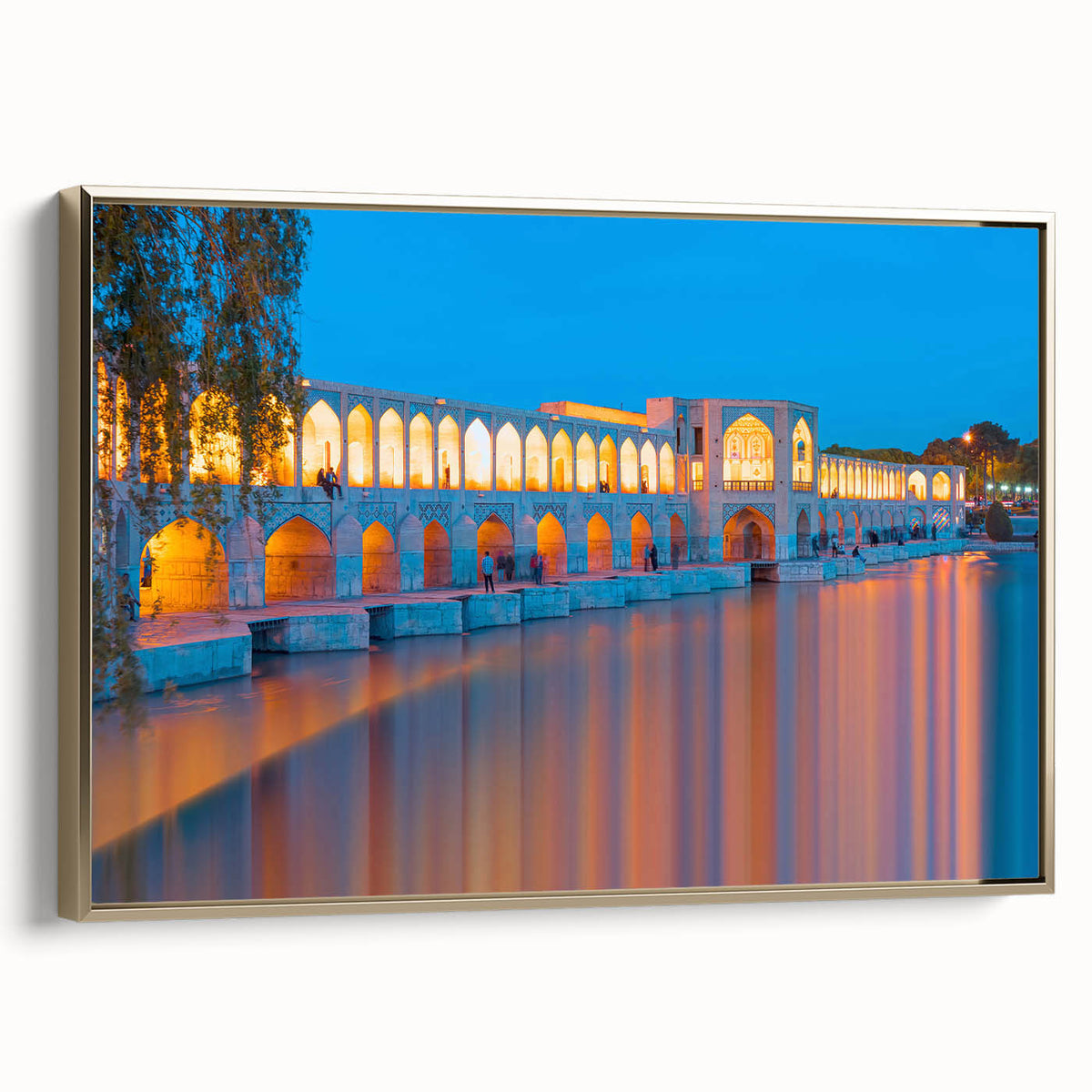 Framed canvas featuring a vintage-style landscape painting of a Middle Eastern scenery in muted gold and black tones.