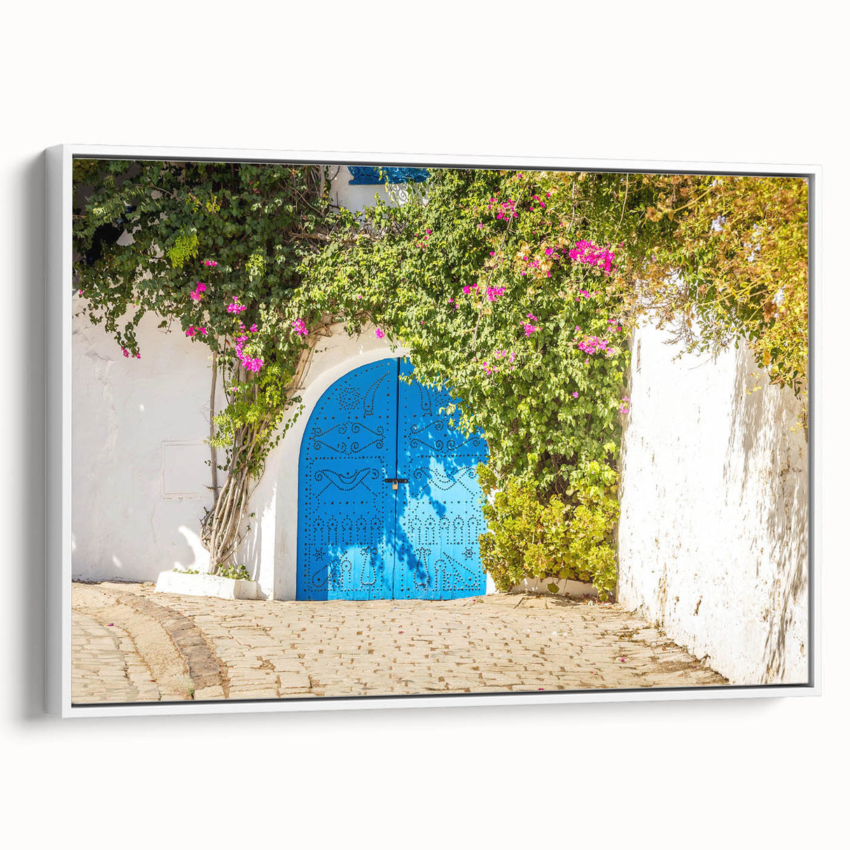 Vintage poster art of a Tunisian landscape on a framed canvas, featuring vibrant colorful art against a black background.