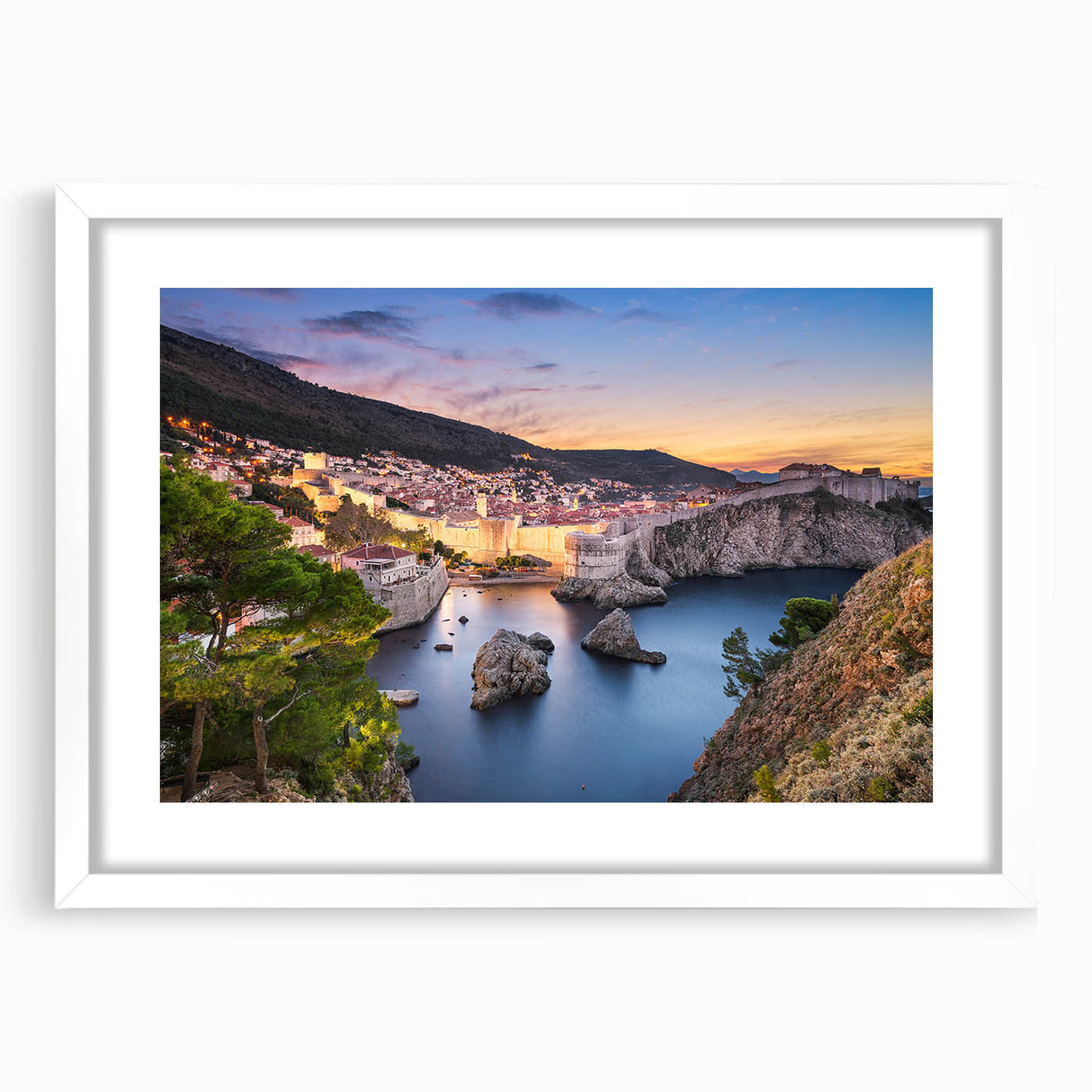 Textured art depicting an abstract European coastline in muted blue and gray tones, framed with a white mat.