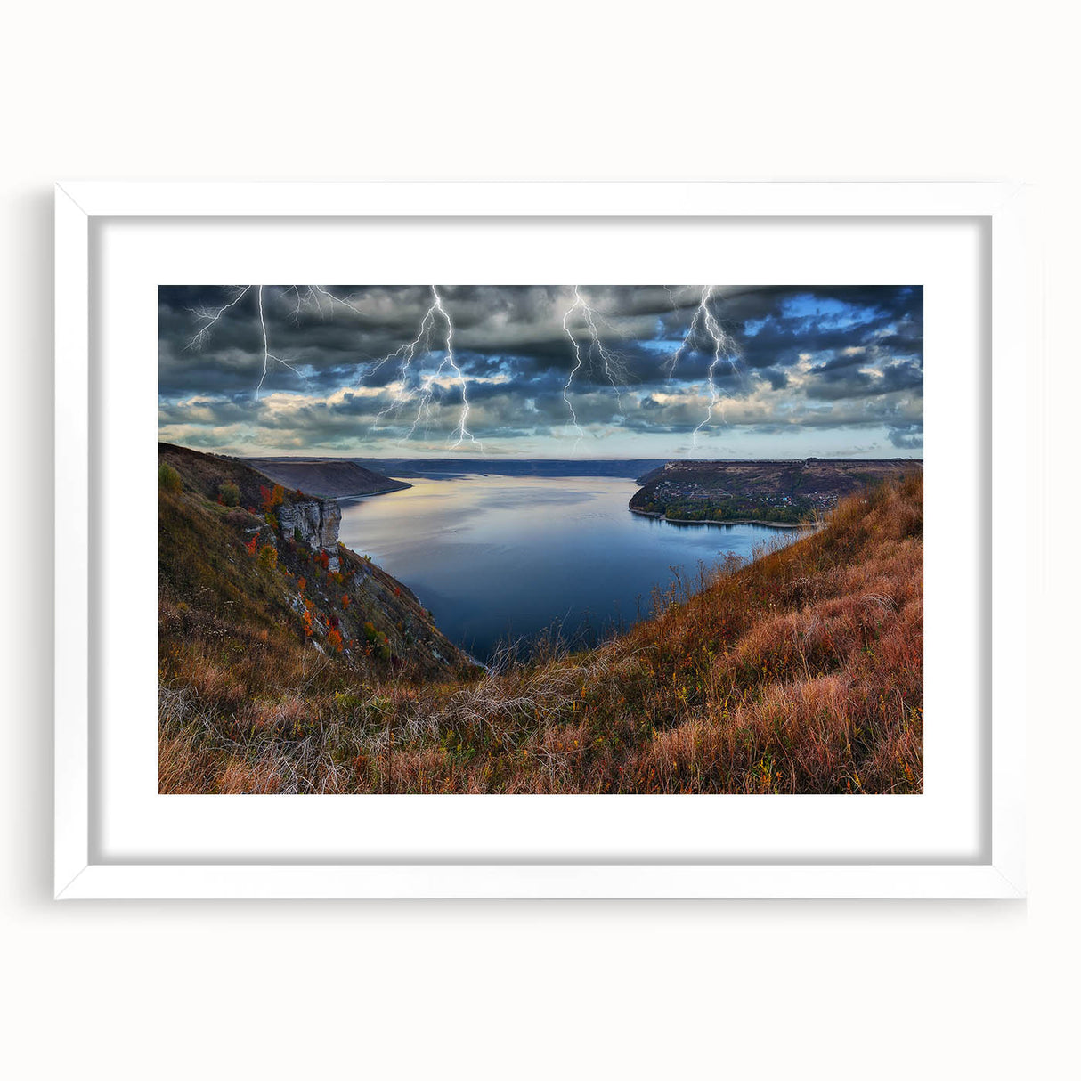 Abstract art print of a European landscape in muted blue and green tones, framed with a white mat.