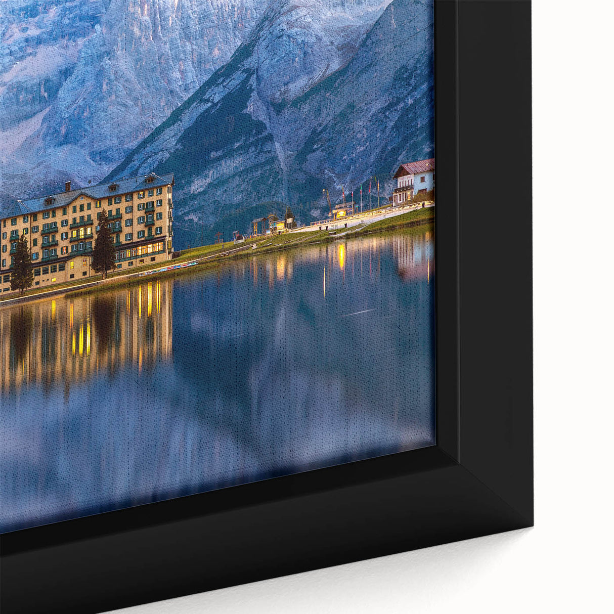 Close-up of a textured black wall art depicting a European scenery in vibrant colors on a framed canvas.