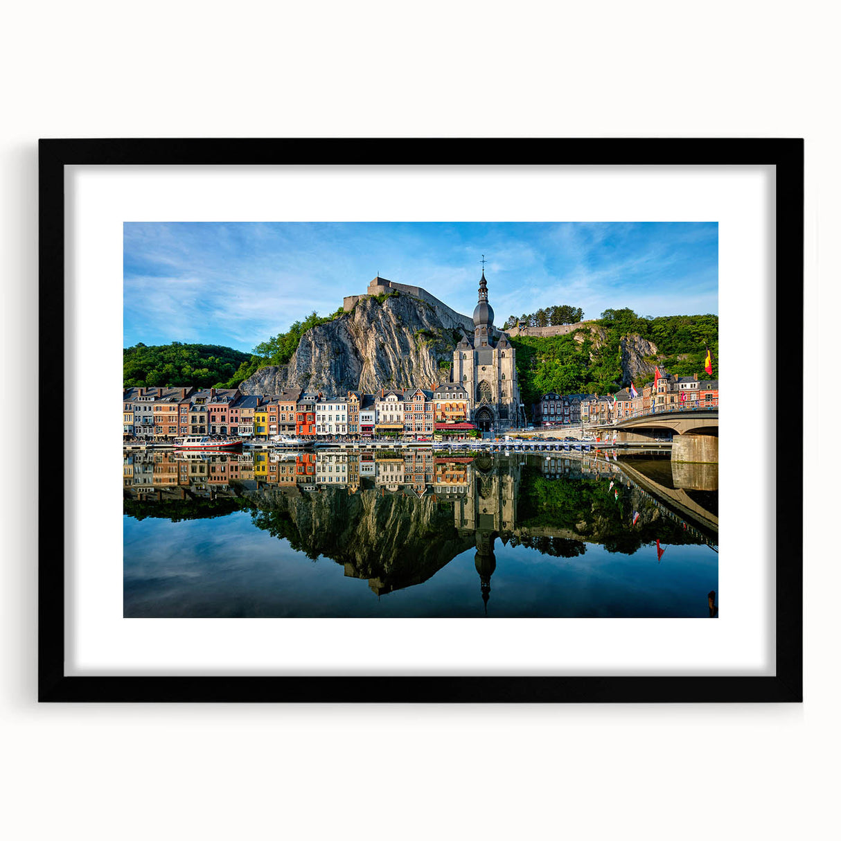 Abstract art print of a colorful European scenery in vibrant shades, framed in black, ideal for living room decor.