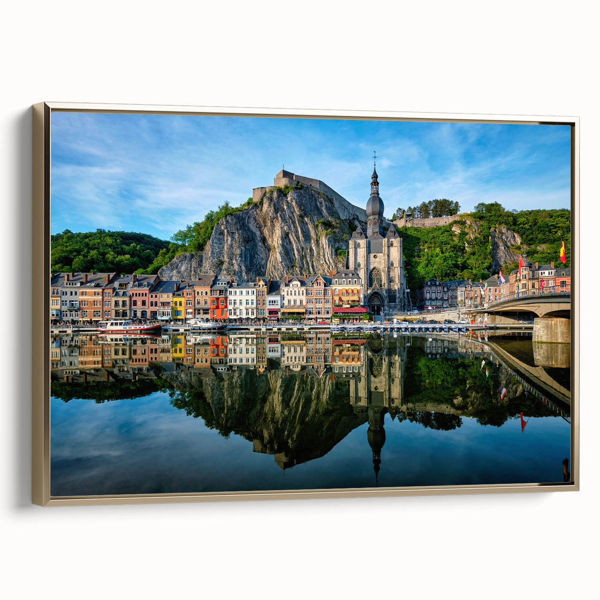 Framed canvas featuring a vintage-style landscape painting of a European scenery in muted gold and black tones.