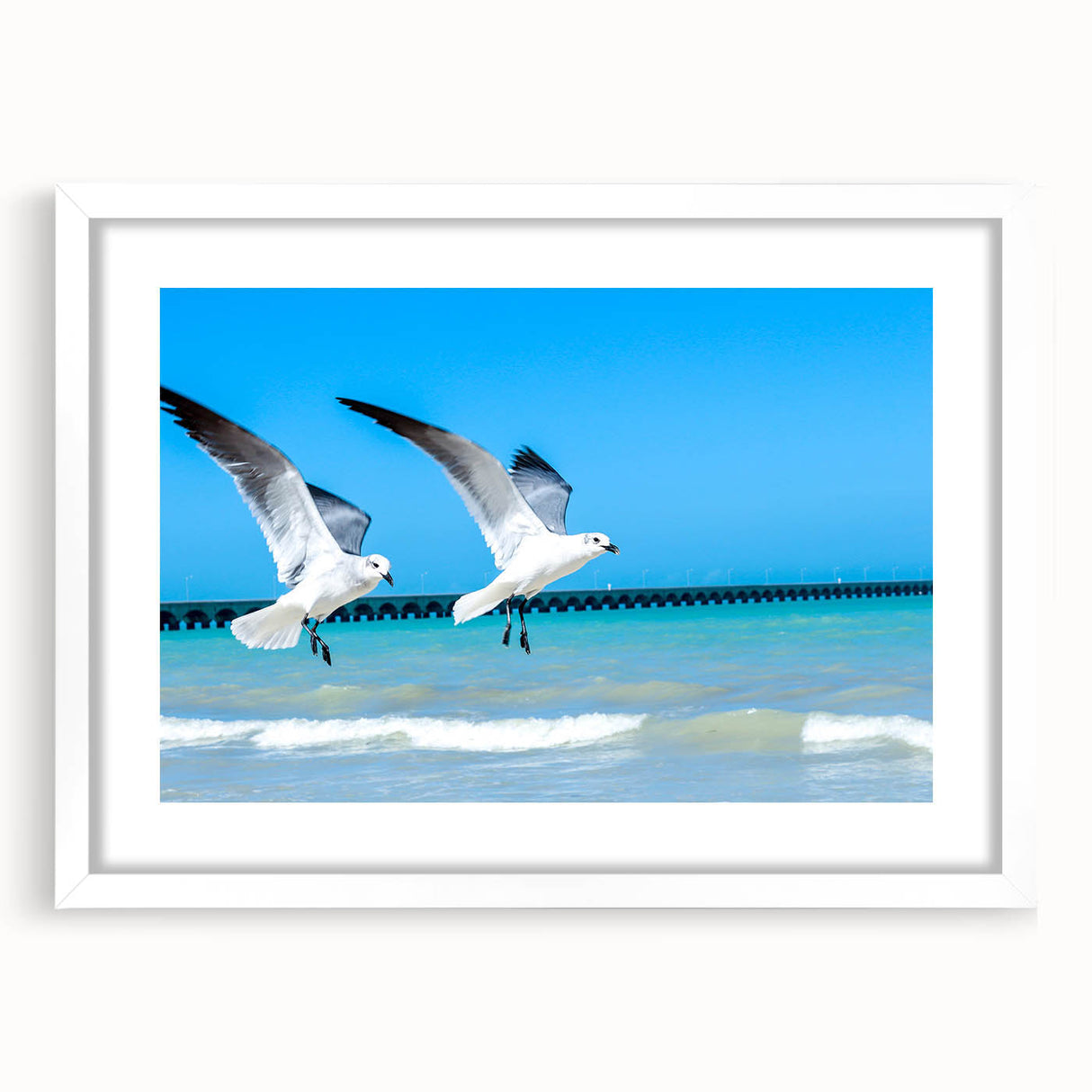 Abstract art print of Yucatan scenery in muted green and blue tones, framed with a white mat, ideal for dining room decor.