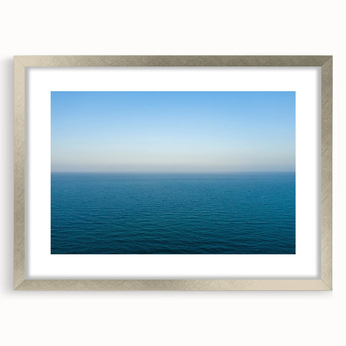 Extra large abstract art print depicting a textured European landscape in muted earth tones, framed in silver.