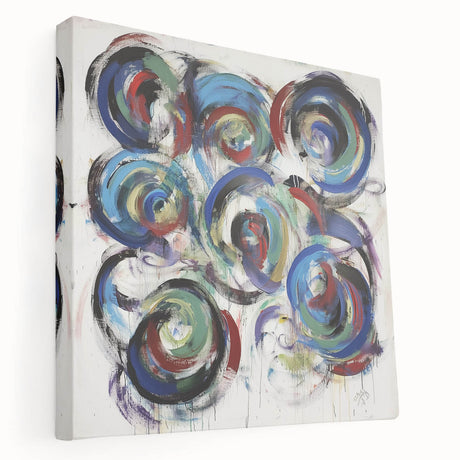 Stretched canvas artwork showcasing vibrant abstract splatters in a range of colors, perfect for modern home decor, displayed from a side view.