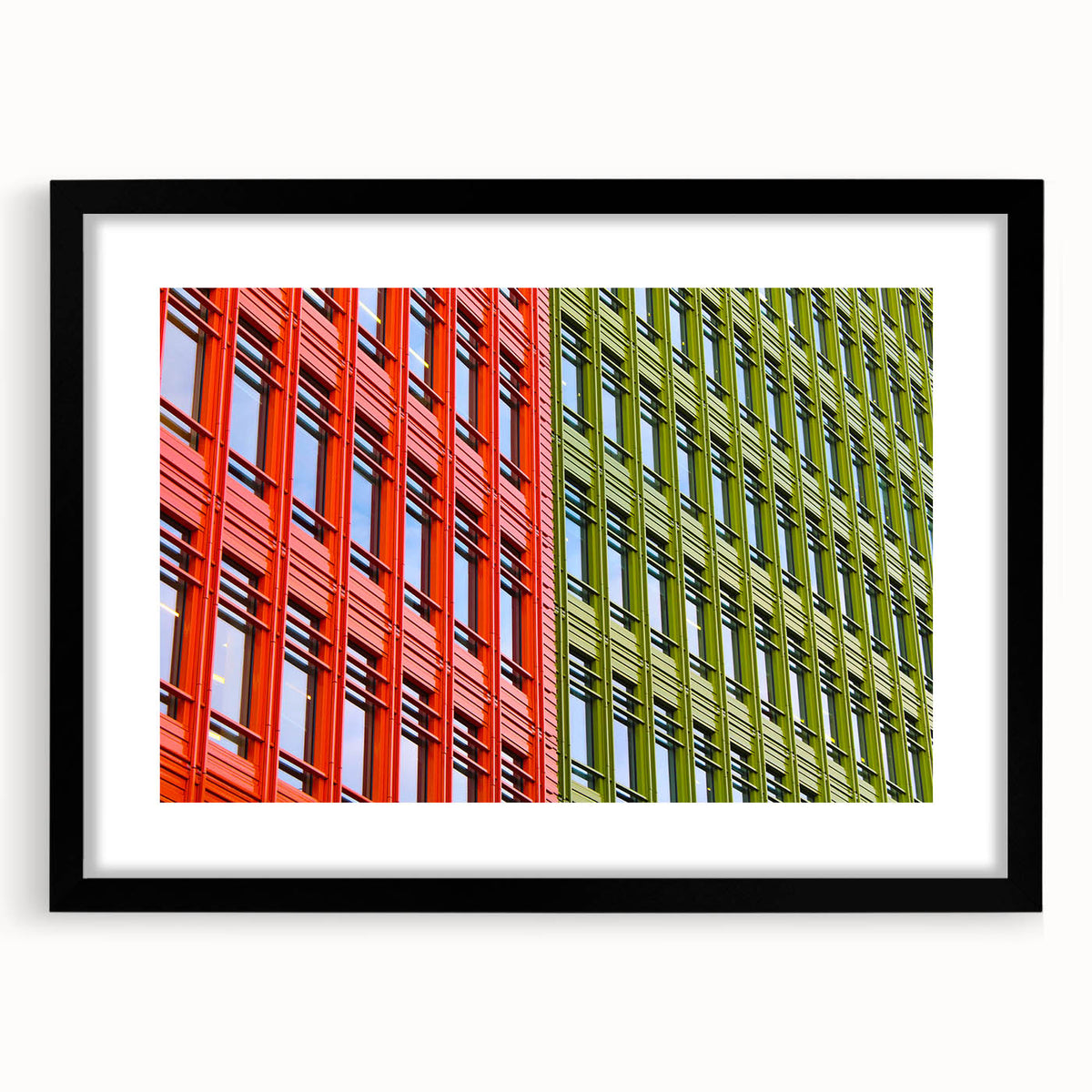 Colorful abstract art print of London scenery in vibrant hues, framed in black, suitable for living room decor.
