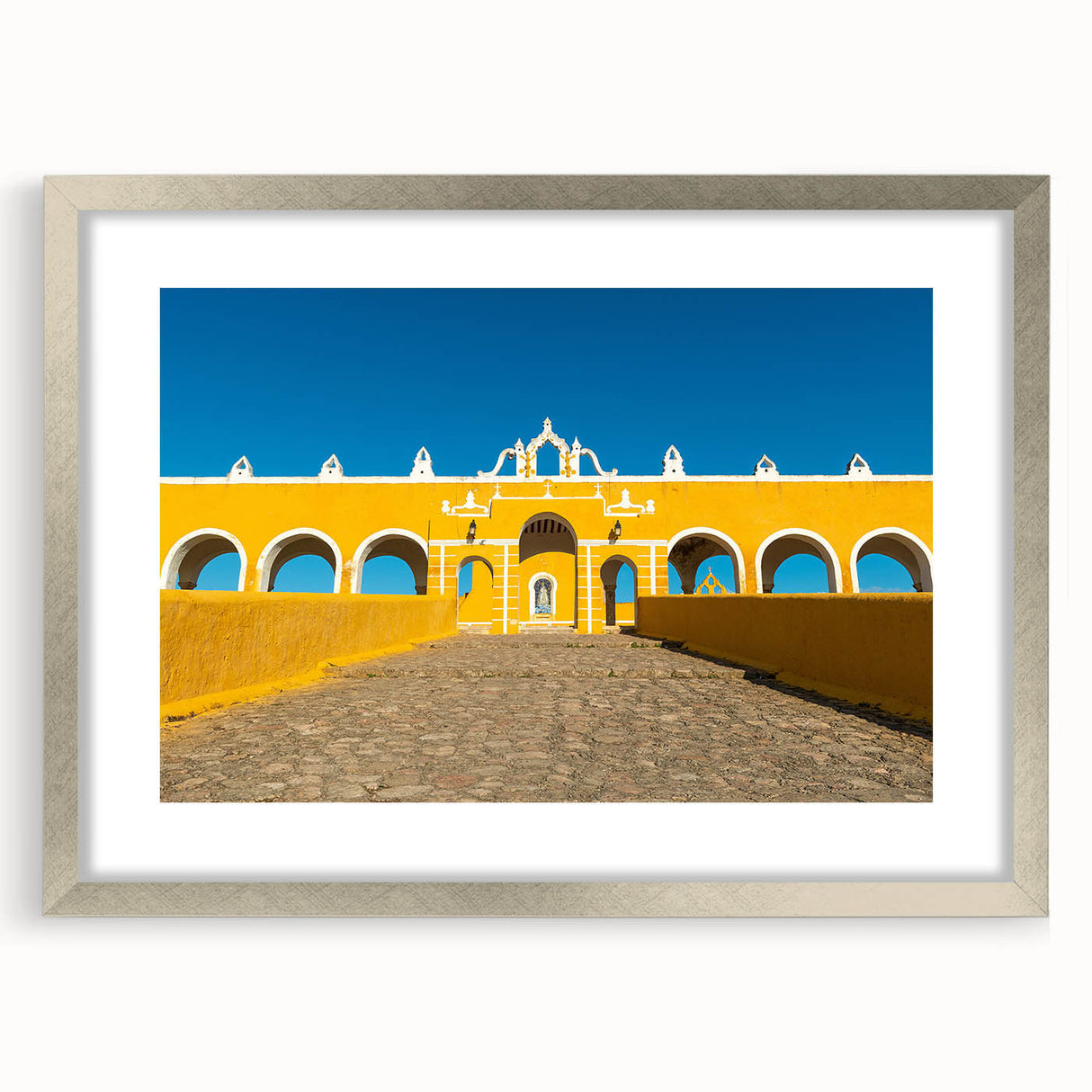 Textured art print of an abstract Yucatan scenery in muted earth tones on a framed silver mat, suited for bedroom art.