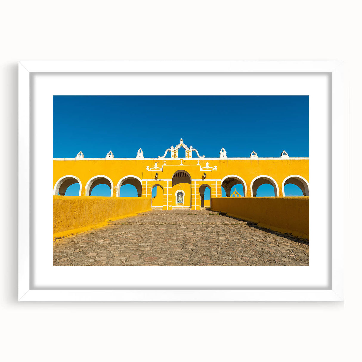 Abstract art print of Yucatan scenery in muted earth tones on a framed white mat, suitable for dining room decor.