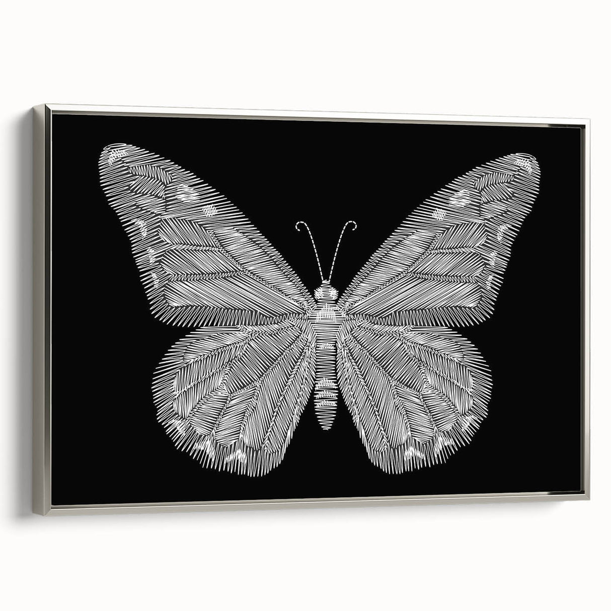 Framed wall art featuring a vibrant butterfly design, showcasing intricate details and a silver frame, perfect for adding a touch of elegance to any room decor.