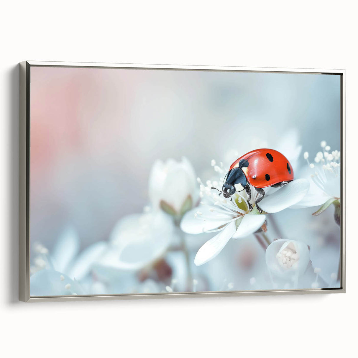 Framed wall art showcasing a vibrant ladybug design, featuring intricate details and a silver frame, perfect for adding a pop of color to any decor.