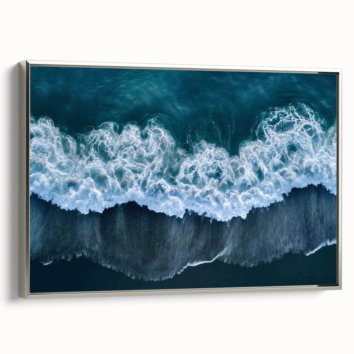 Framed canvas wall art showcasing a serene beach landscape with silver accents, designed to enhance home decor with a tranquil coastal vibe. Ideal for modern interiors.