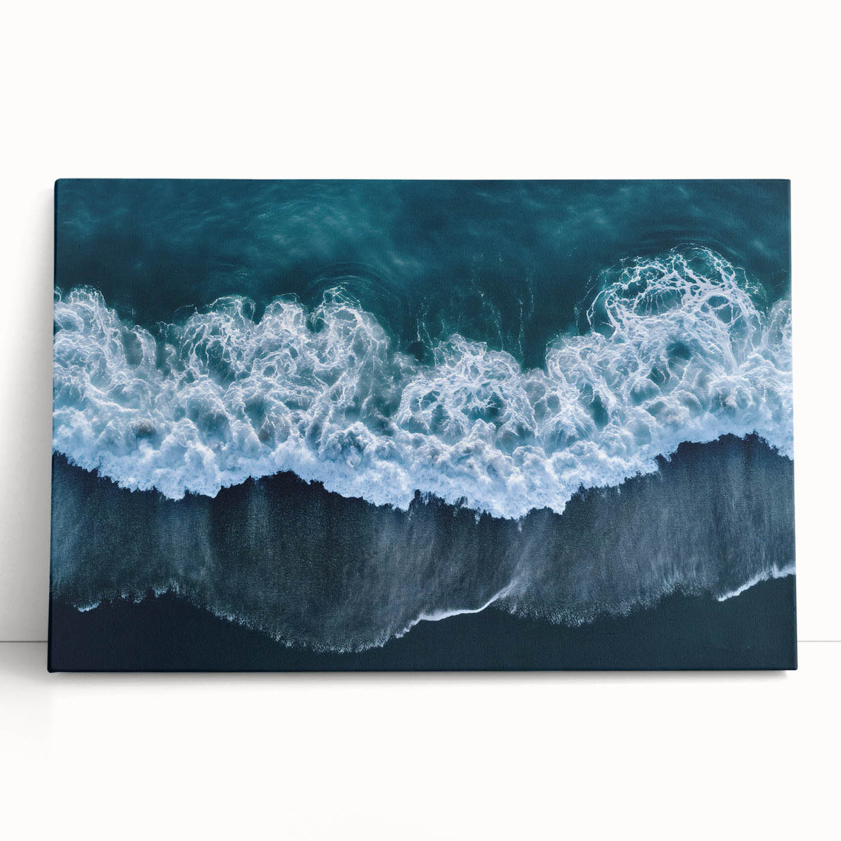 Vibrant stretched canvas artwork depicting a serene beach landscape with gentle waves and a clear blue sky, perfect for home decor or coastal-themed interiors.