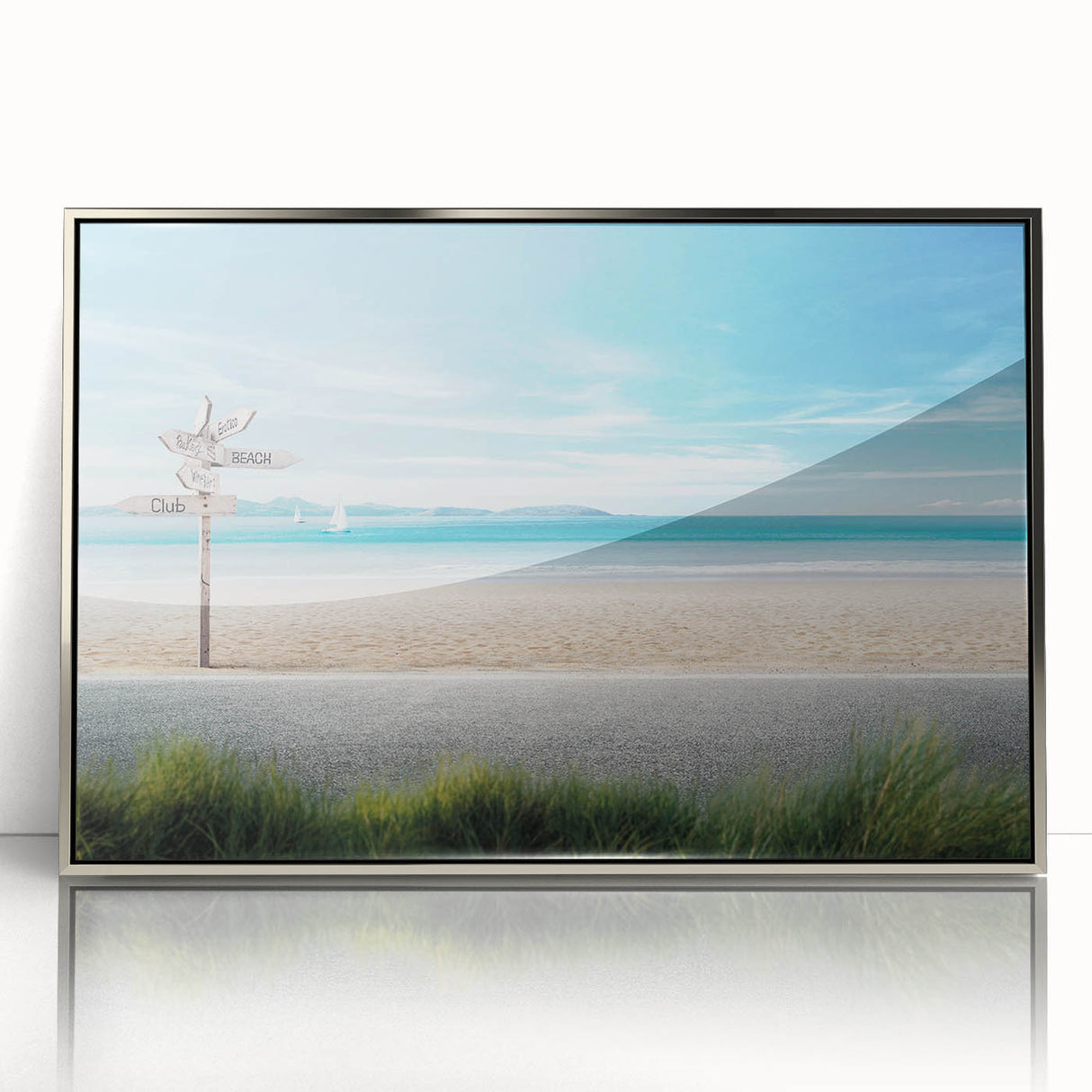 Framed wall art of a serene beach landscape featuring soft blue hues and golden sand, elegantly encased in a silver frame, perfect for coastal decor.