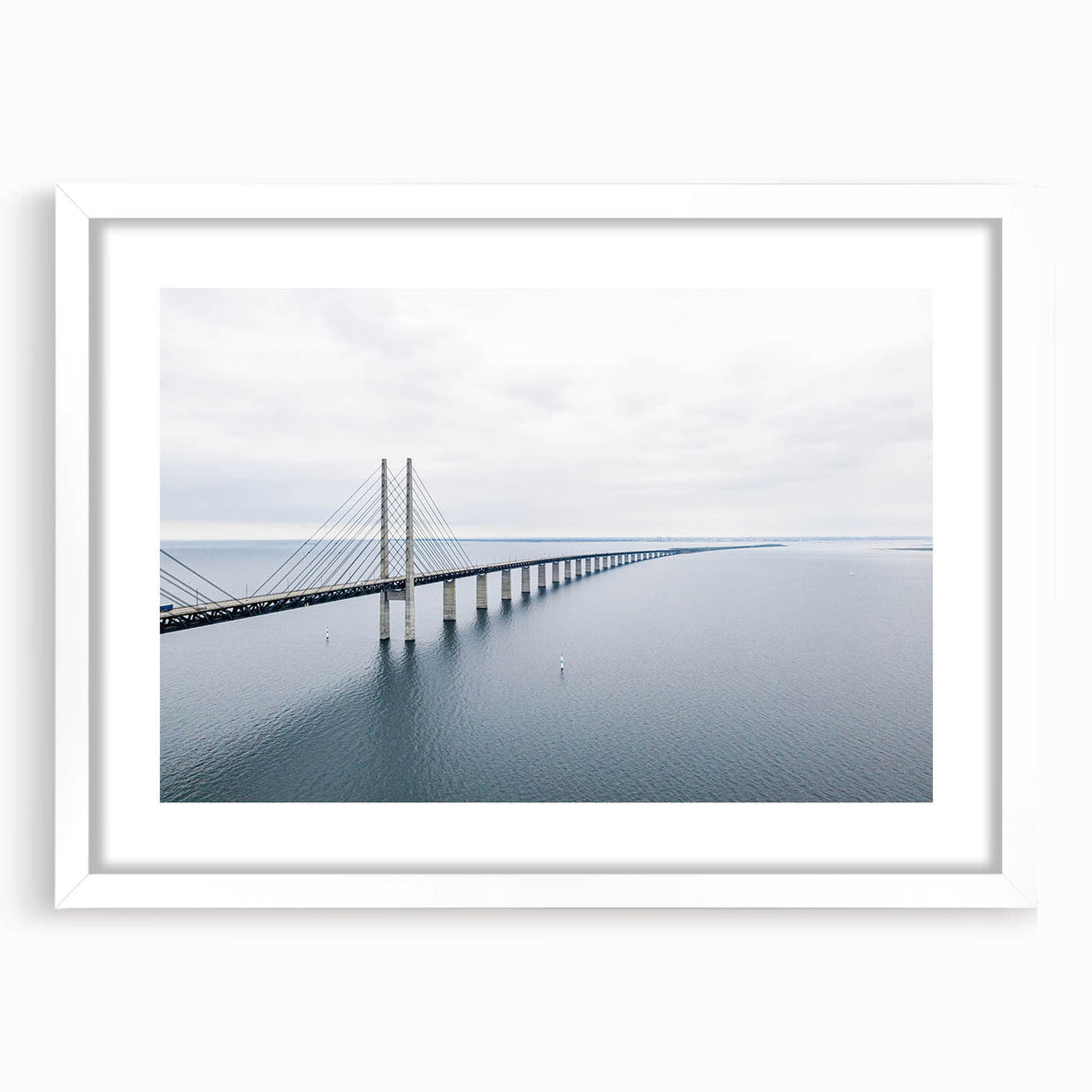 Framed wall art featuring a serene landscape with a bridge, presented in a white mat and sleek frame, ideal for enhancing home decor aesthetics.