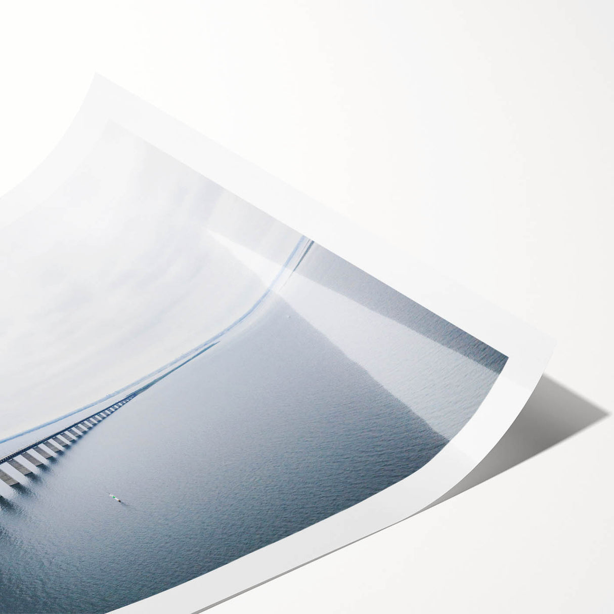 Rolled print showcasing a vibrant landscape bridge design in warm hues, perfect for home decor; packaged securely in a protective cardboard tube.