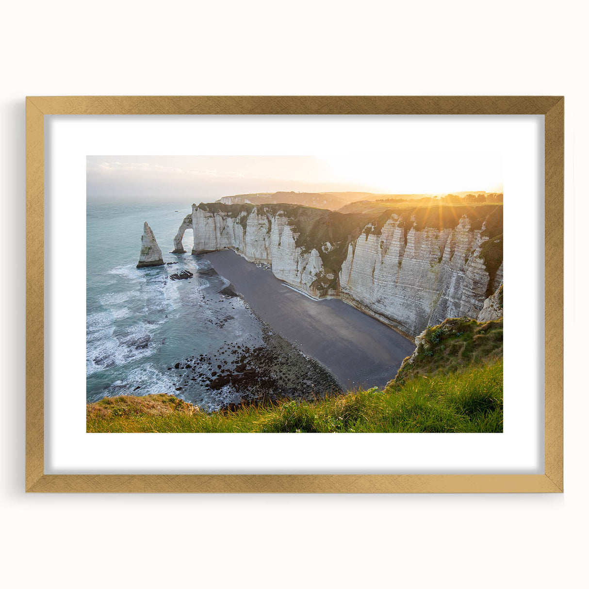 Framed wall art featuring a striking landscape of cliffs in earthy tones, accented by a gold mat, showcasing natural beauty and elegance in home decor.
