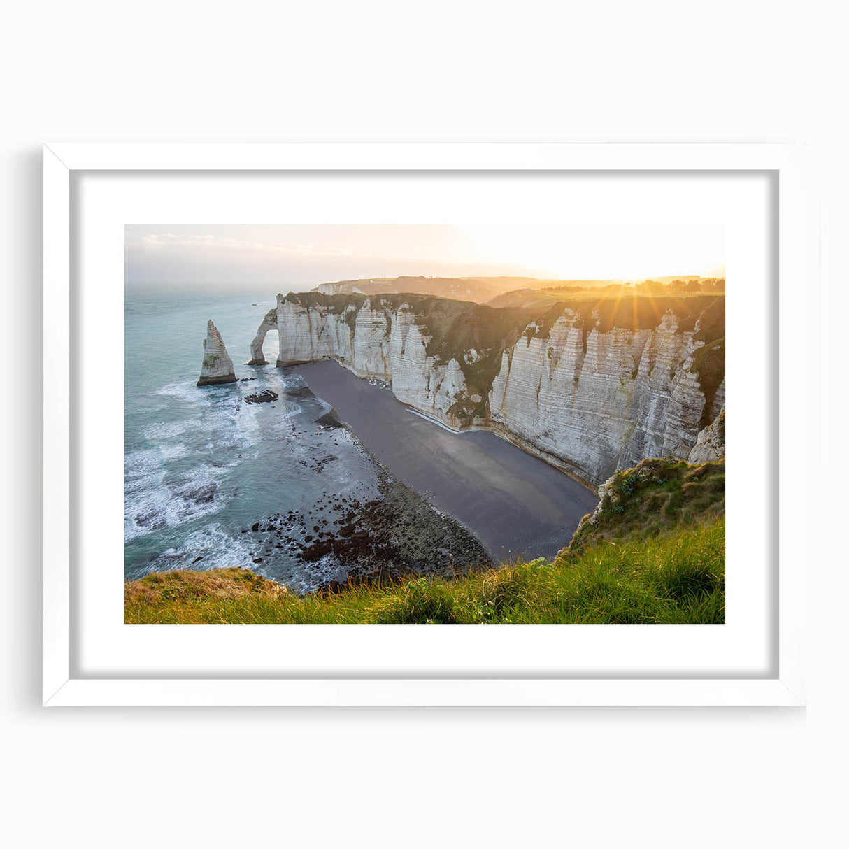 Framed wall art featuring a stunning landscape of cliffs and ocean waves, elegantly matted with a white border, perfect for home decor enhancement.